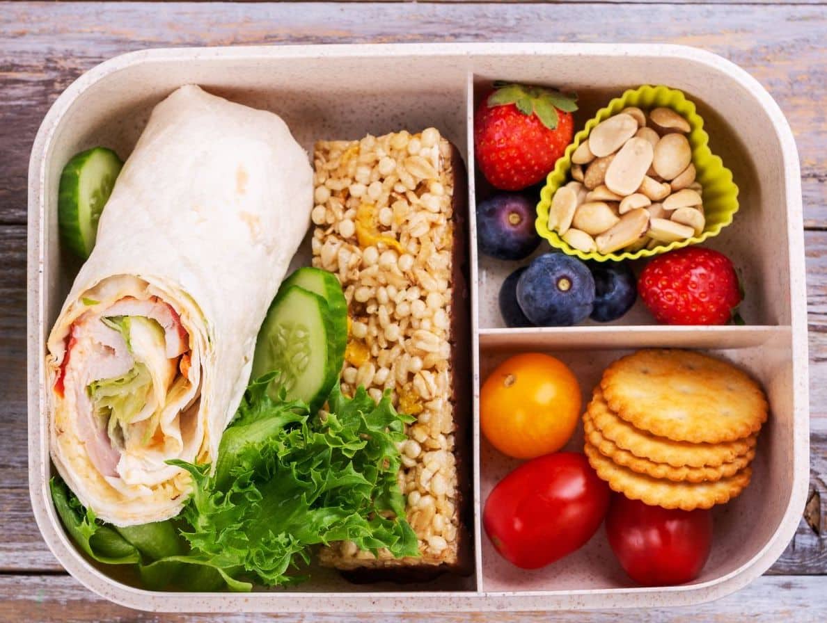 Sample multi-tasking lunch or food that can be eaten with one hand. Meat, cheese, lettuce roll-up, cucumbers, strawberries, blueberries, nuts, cherry tomatoes.