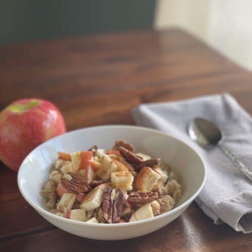 Apple cinnamon anti-inflammatory oatmeal topped with diced apples, flax, cinnamon, and pecans
