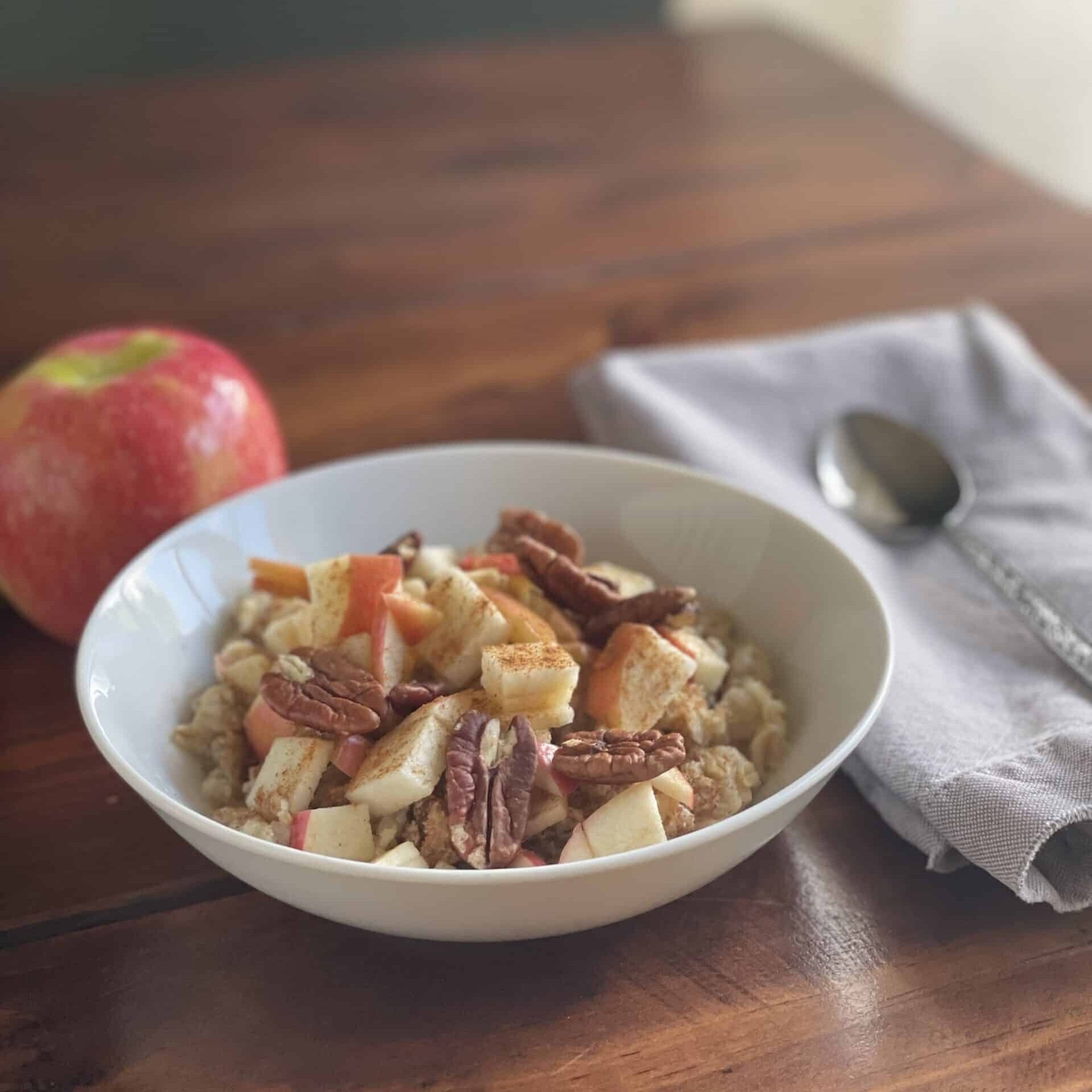 Apple cinnamon anti-inflammatory oatmeal topped with diced apples and pecans