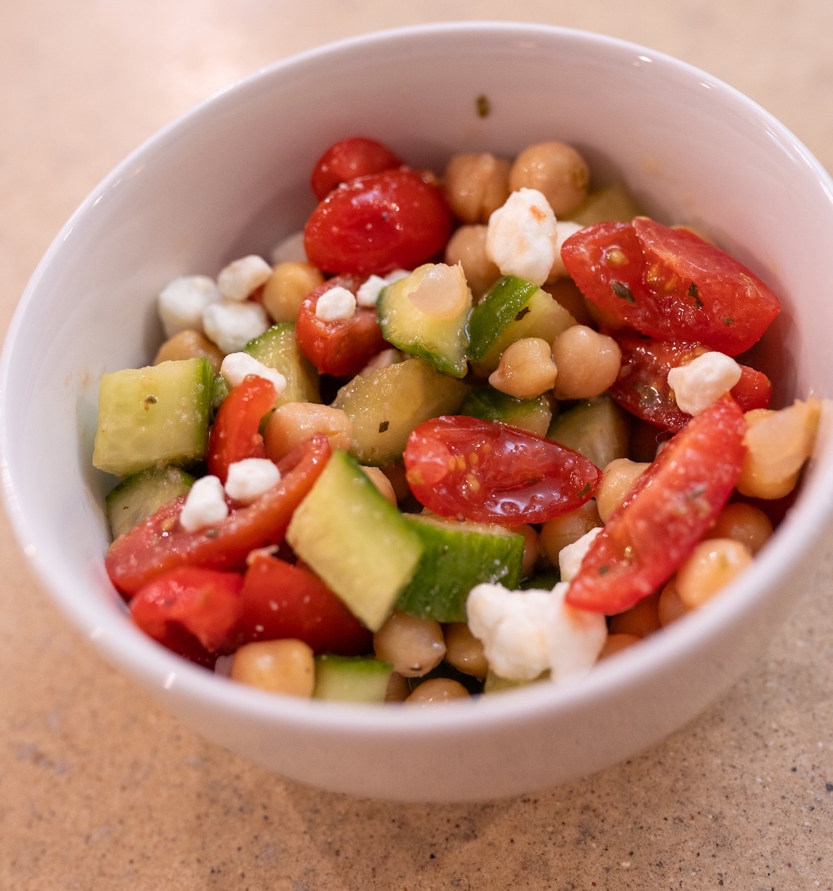 Homemade Mediterranean chickpea salad with chickpeas, cucumber, tomatoes, and feta cheese, a simple make-ahead meal-prep recipe.