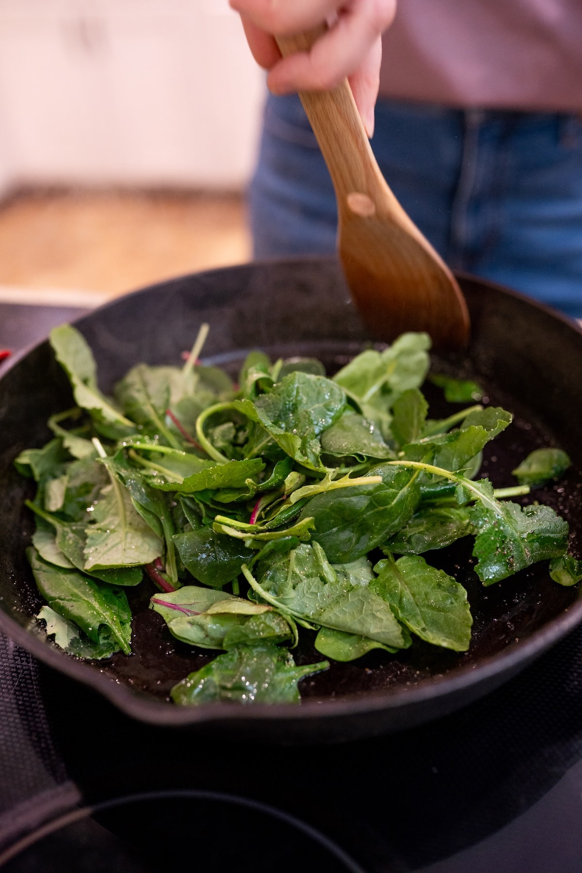 Sautéed leafy greens in a skillet for an anti-inflammatory diet and hot flash support.
