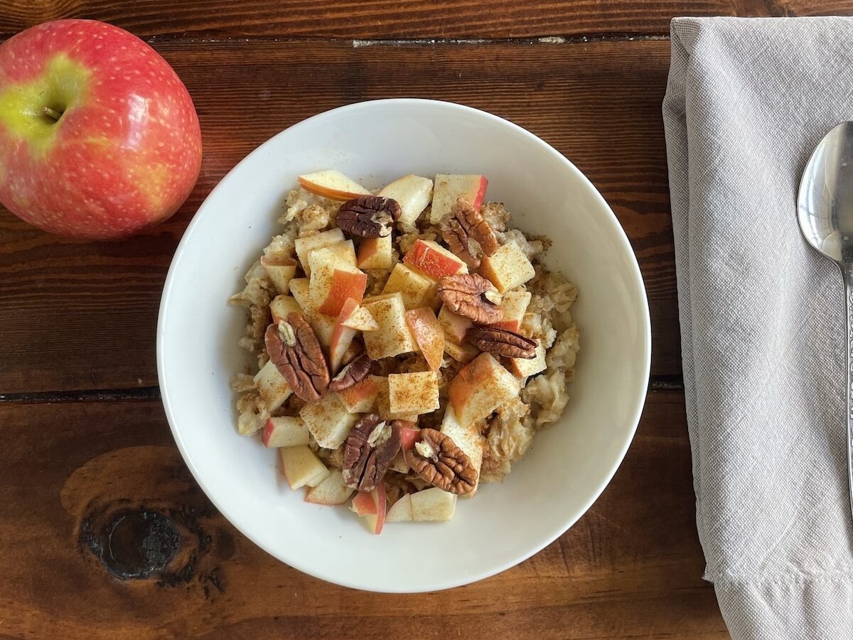 Apple cinnamon anti-inflammatory oatmeal topped with diced apples, flax, cinnamon, and pecans