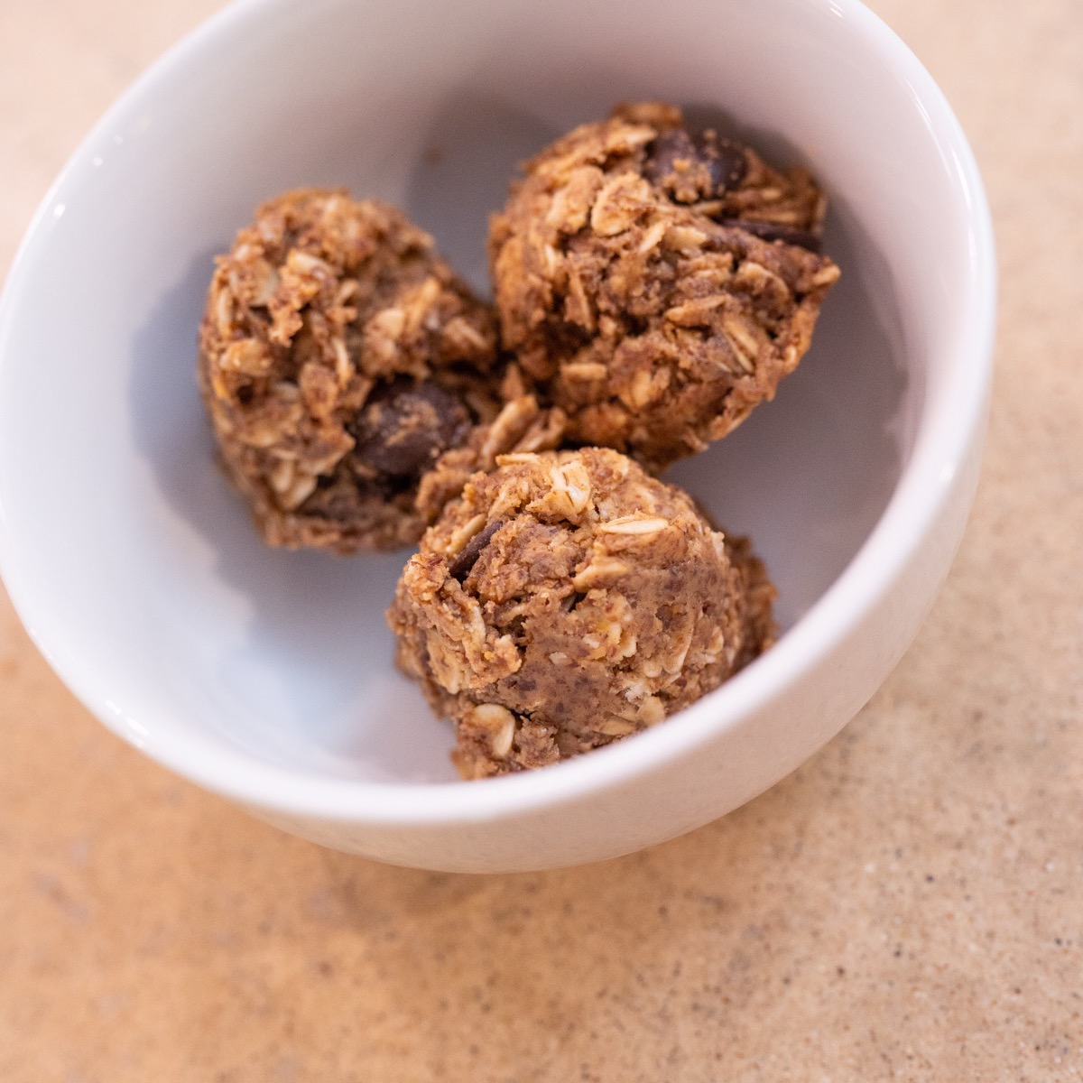 Anti-inflammatory protein balls made with oats and peanut butter in a white bowl